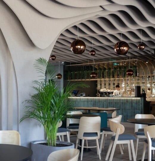Modern restaurant with sculpted acoustic ceiling and pendant lights